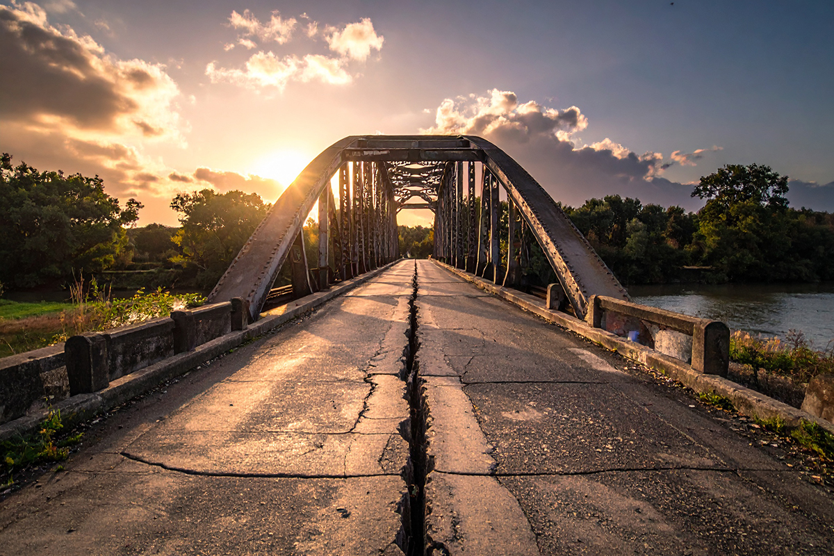 Cracking road under bridge