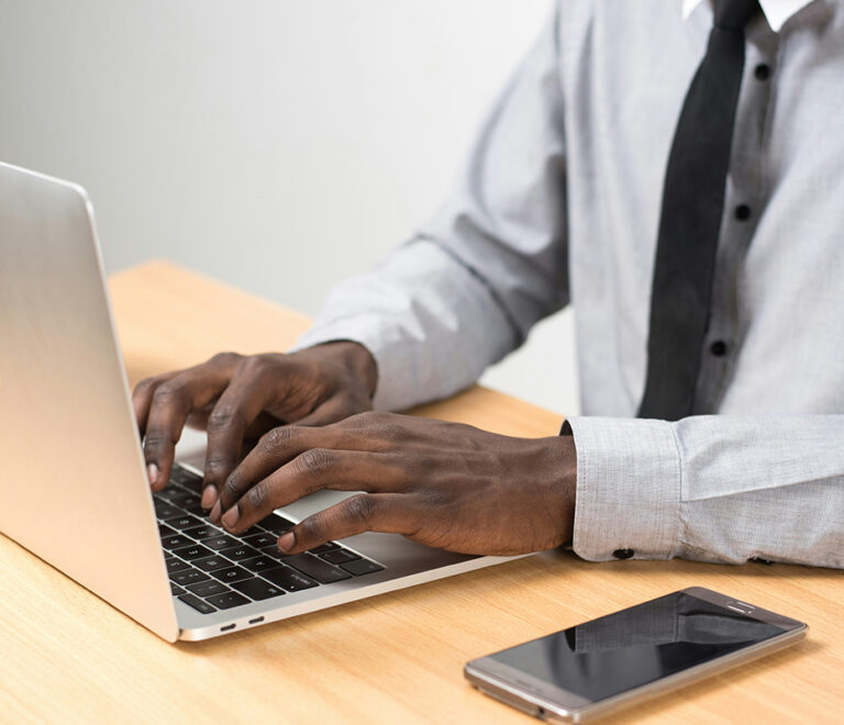 Man typing on a laptop